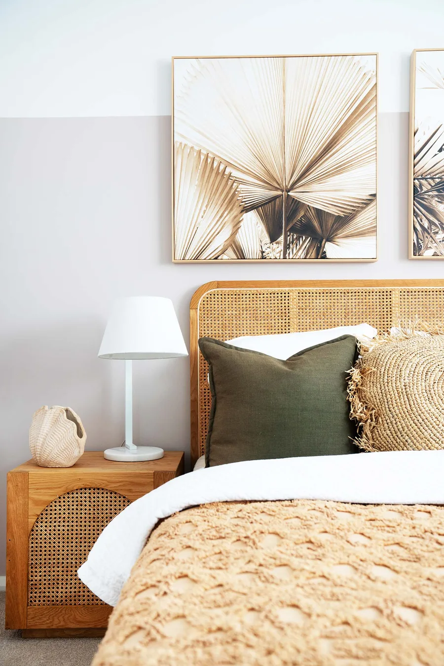 A coastal bedroom interior with a rattan bedhead and natural textures