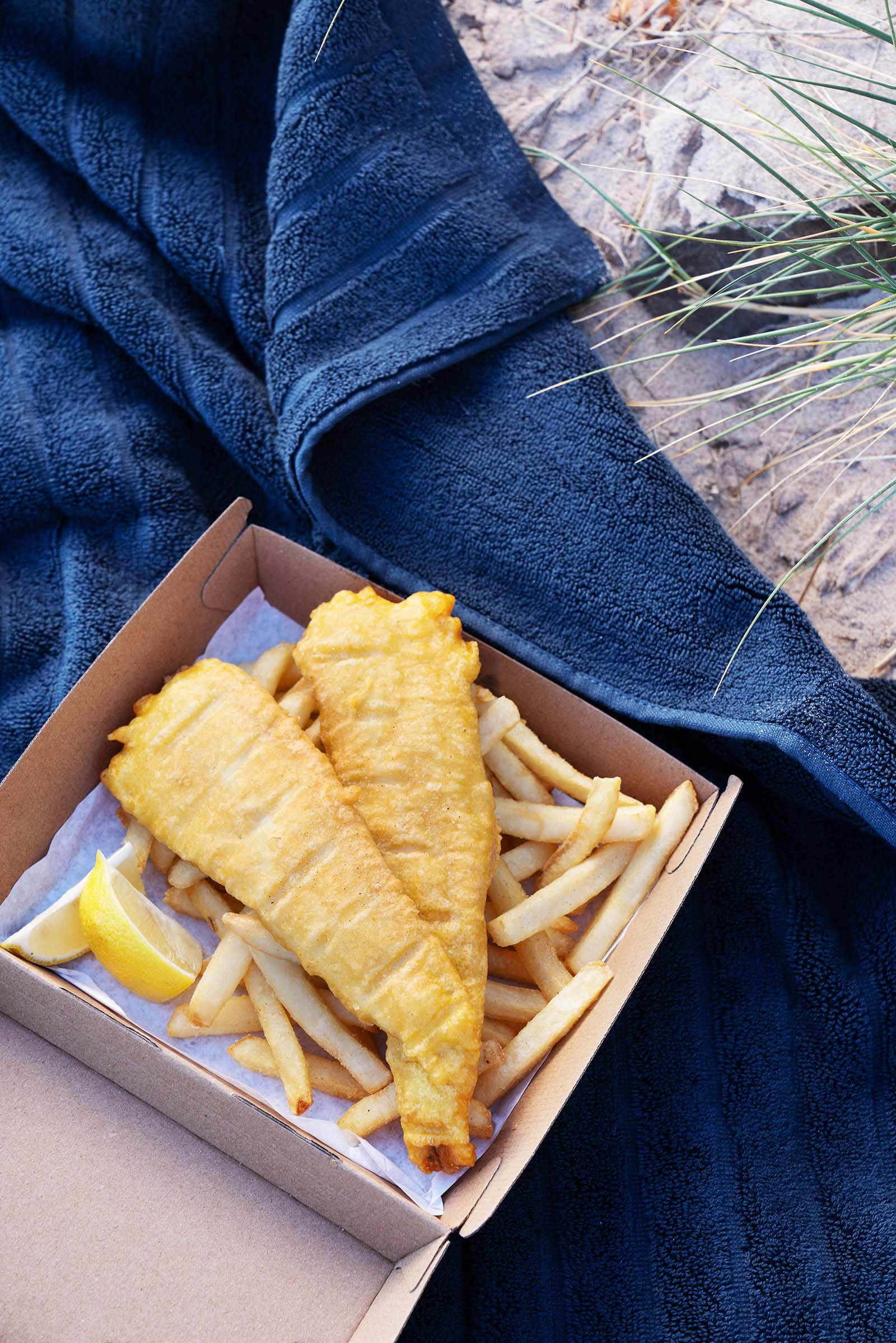 Fish and chips on a beach towel
