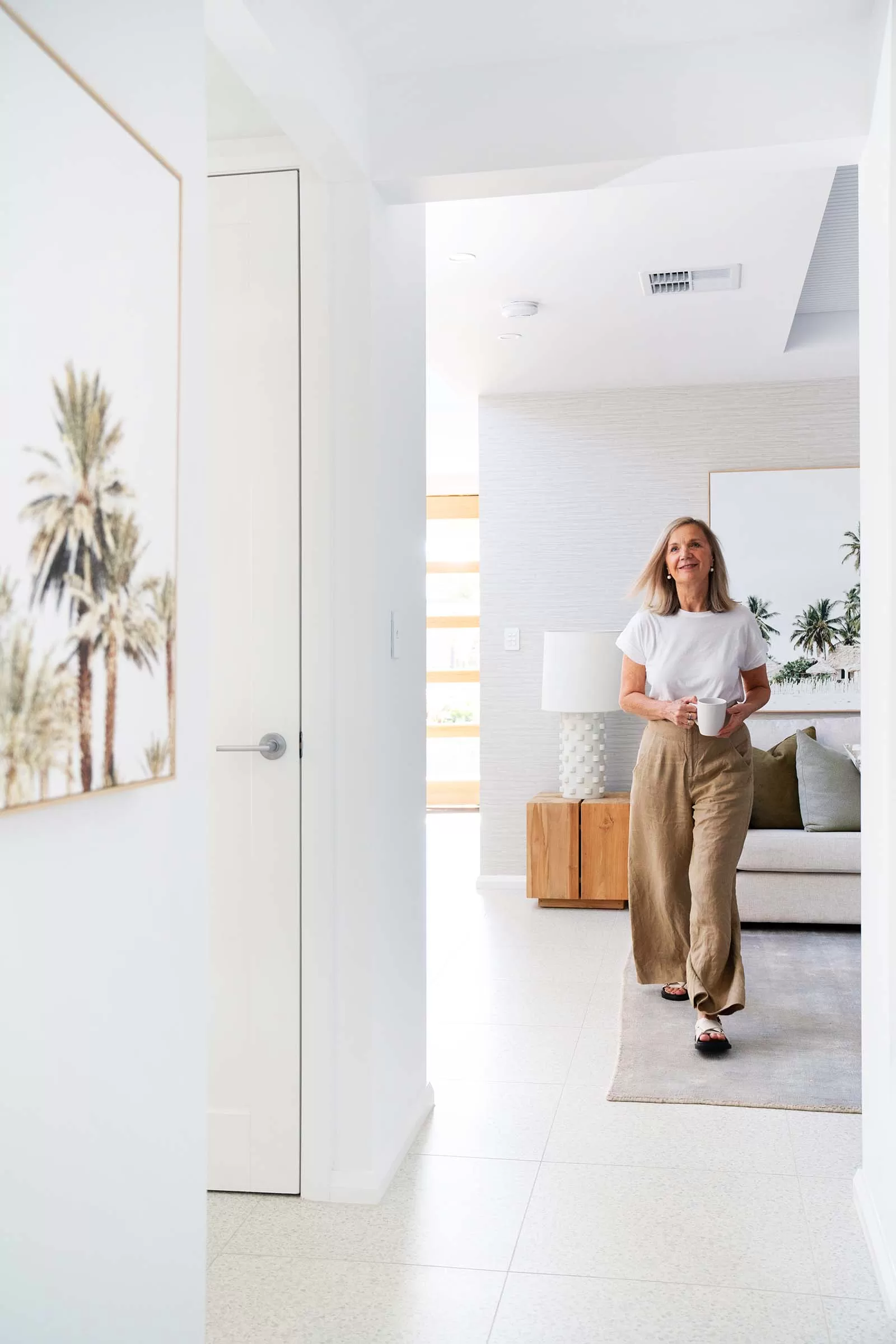 Woman walking through a bright, modern home interior